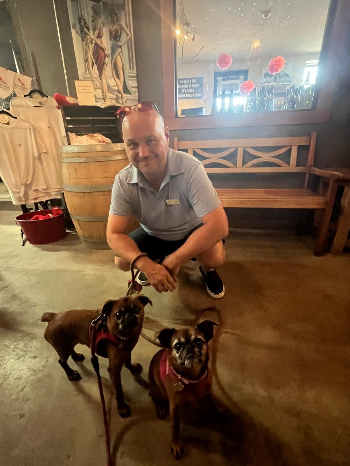 Keith Glover caring for two leashed dogs during a Kelowna wine tour